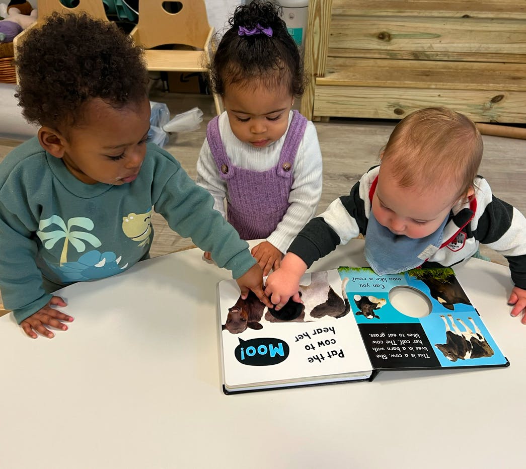 Three children looking at a book together
