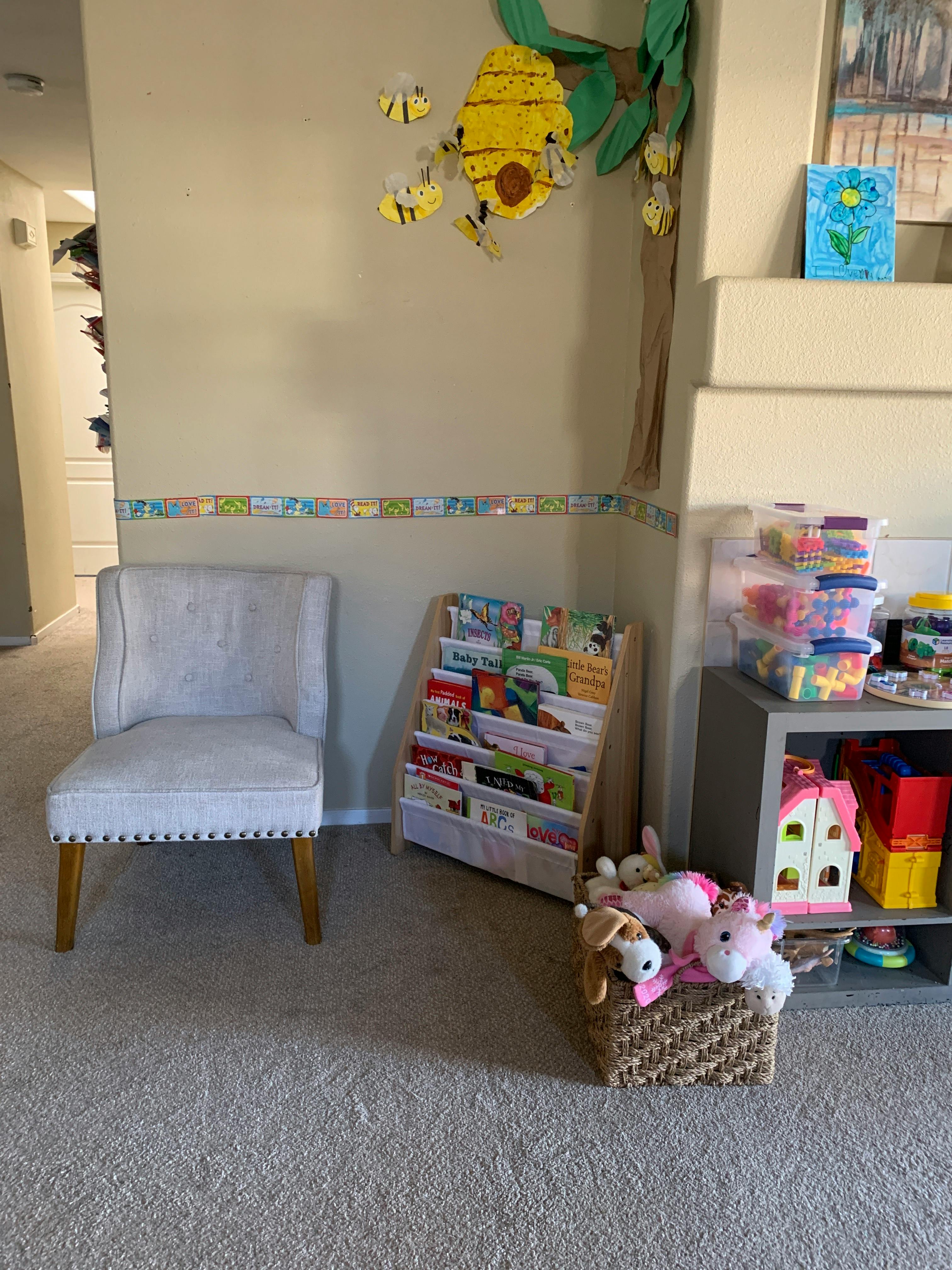 Child's room with a chair, bookshelf, and toys