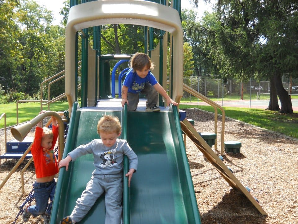 Children playing on a playground slide