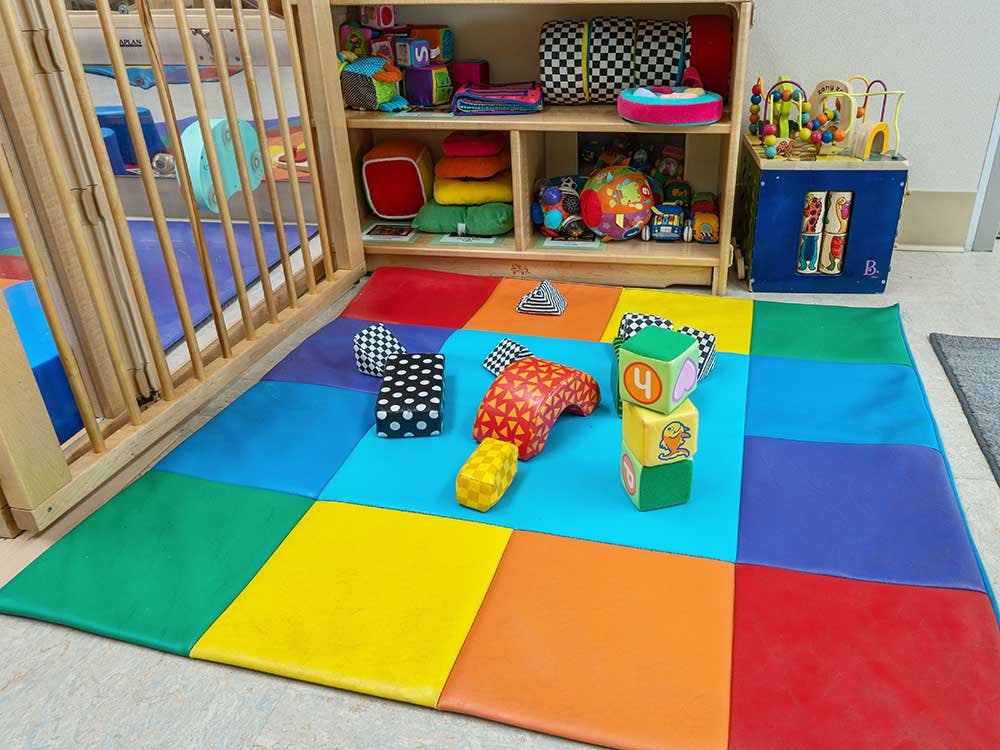 Colorful playmat with blocks and toys in a playroom
