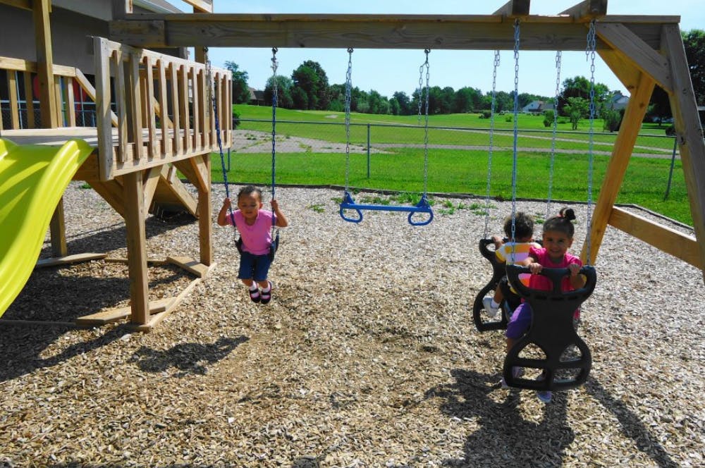 Two children on swings at a playground