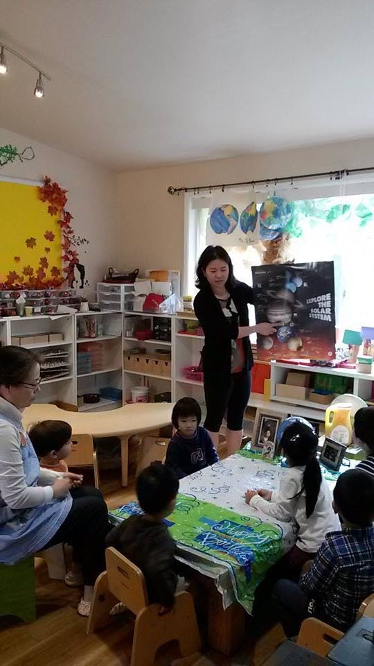 Person holding a poster for children in a classroom