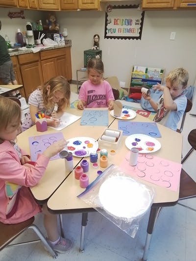 Children doing crafts at a table