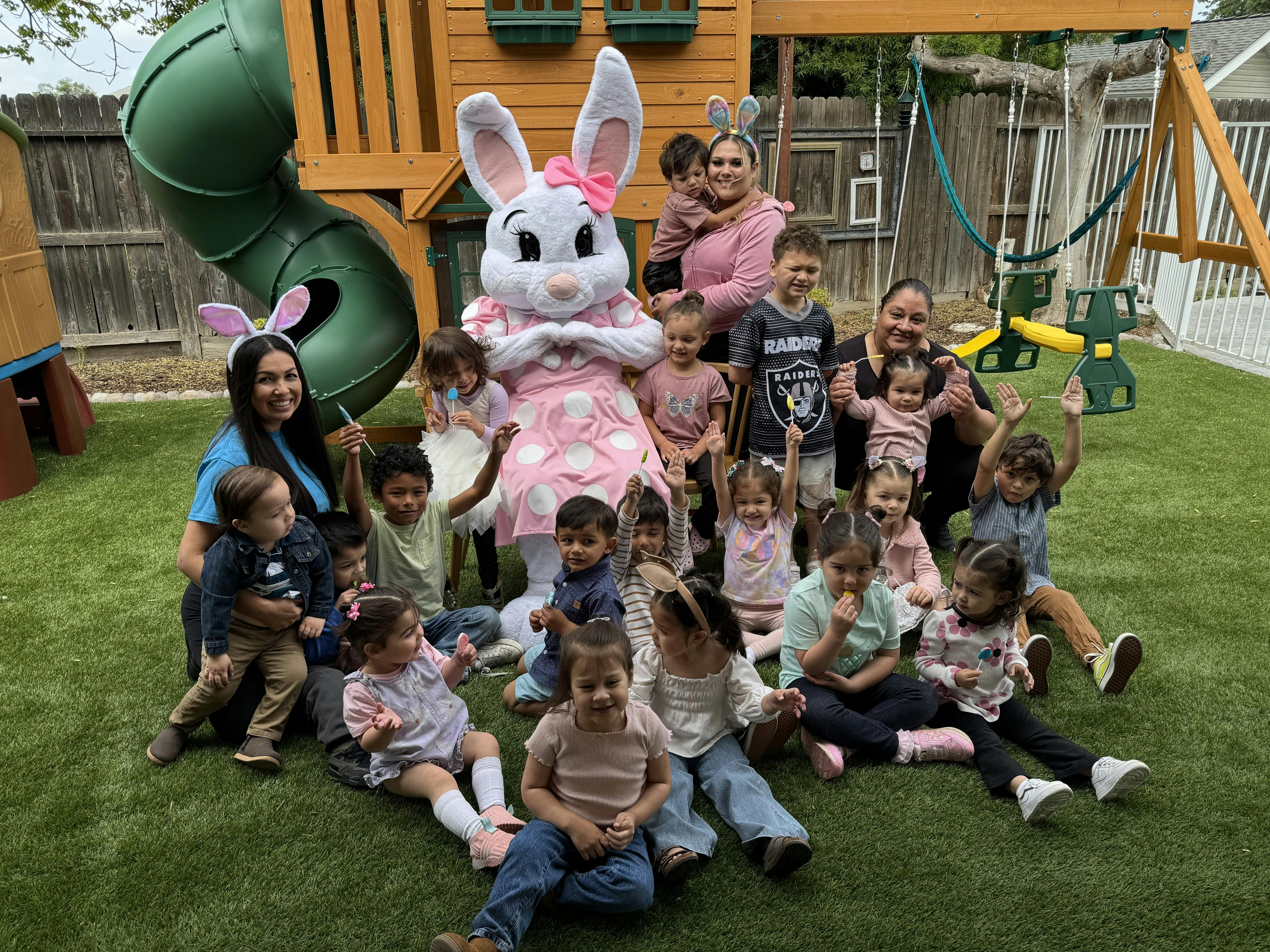 People and children posing with a person in a bunny costume