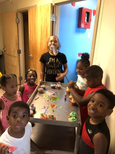 Children decorating cupcakes and cookies