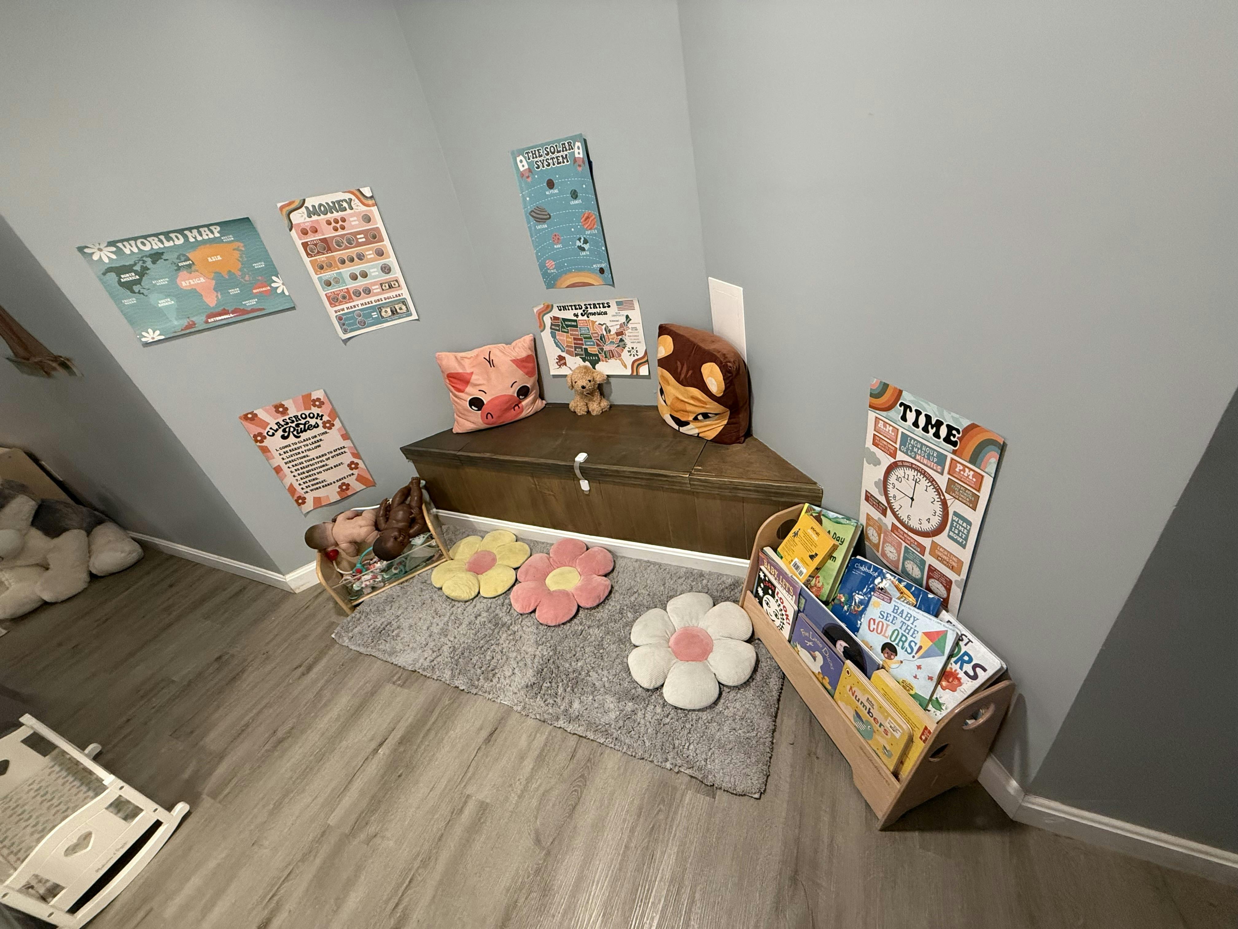 Child learning corner with educational wall posters, toy storage, and books