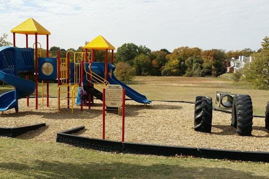 Playground with blue and yellow equipment and tire climbers