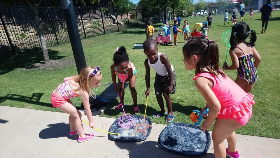 Children playing with bubbles outdoors