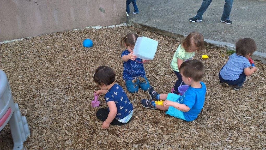 Children playing on wood chips