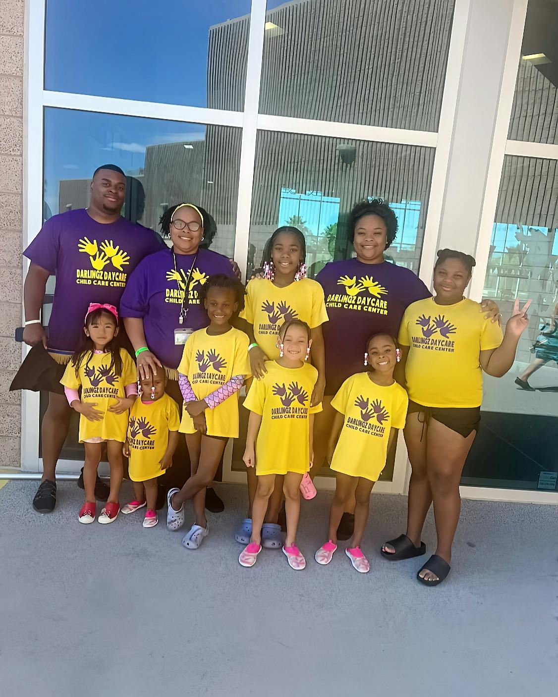 Group of adults and children wearing matching shirts for Darlingz Daycare