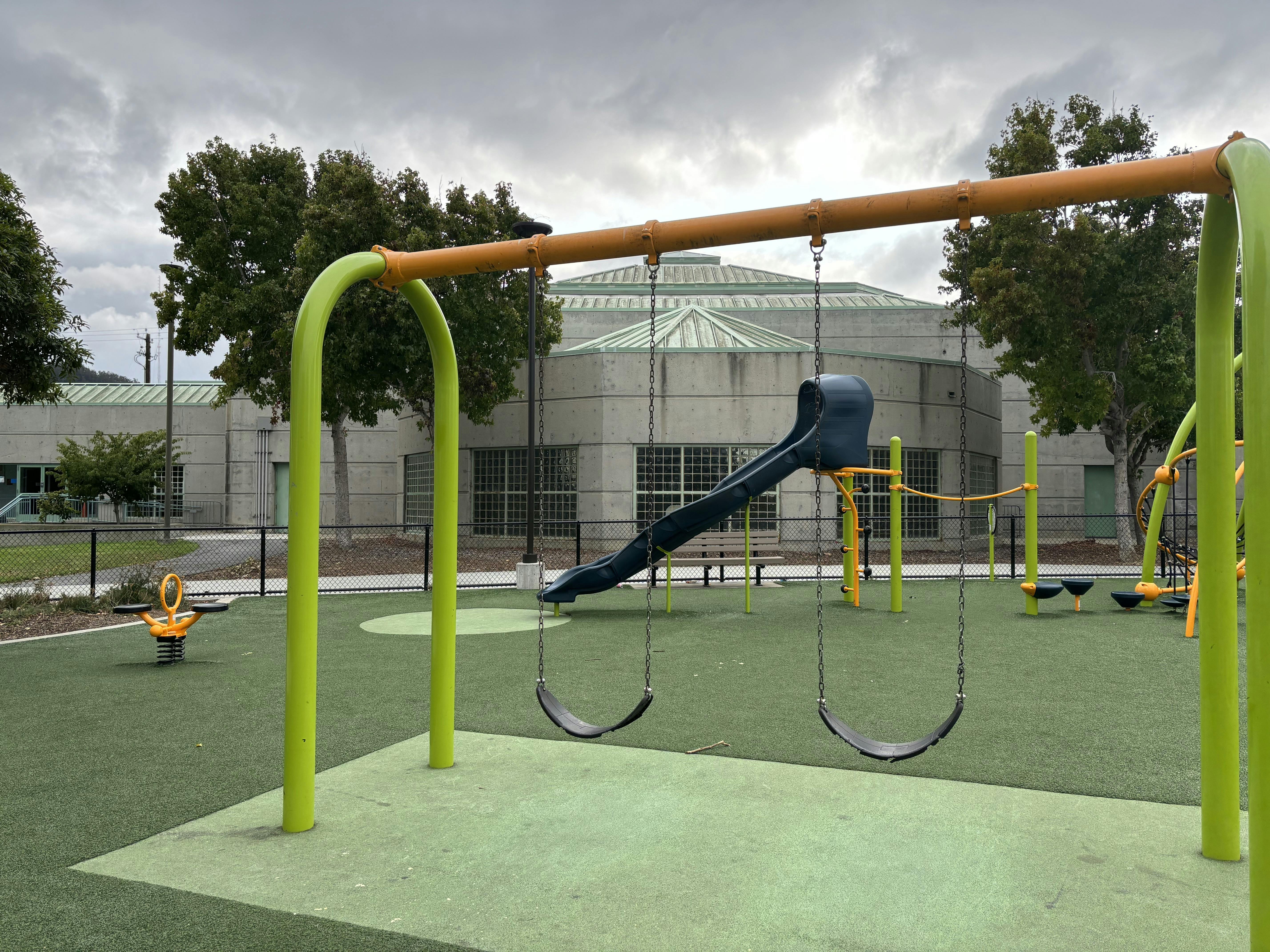 Empty playground with swings and a slide