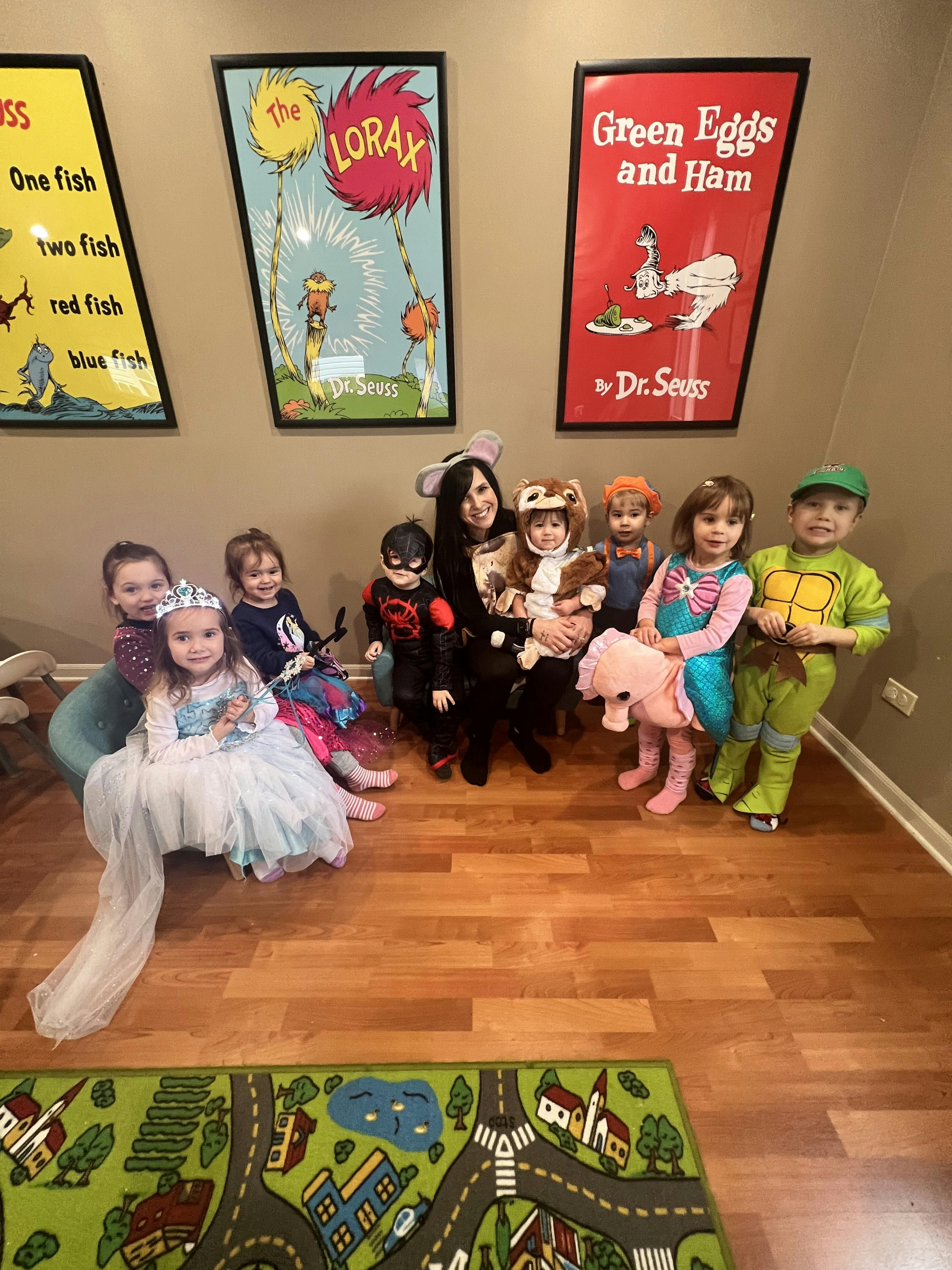 Adult and children in costumes posing for a photo