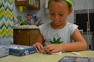 Child playing with small game pieces