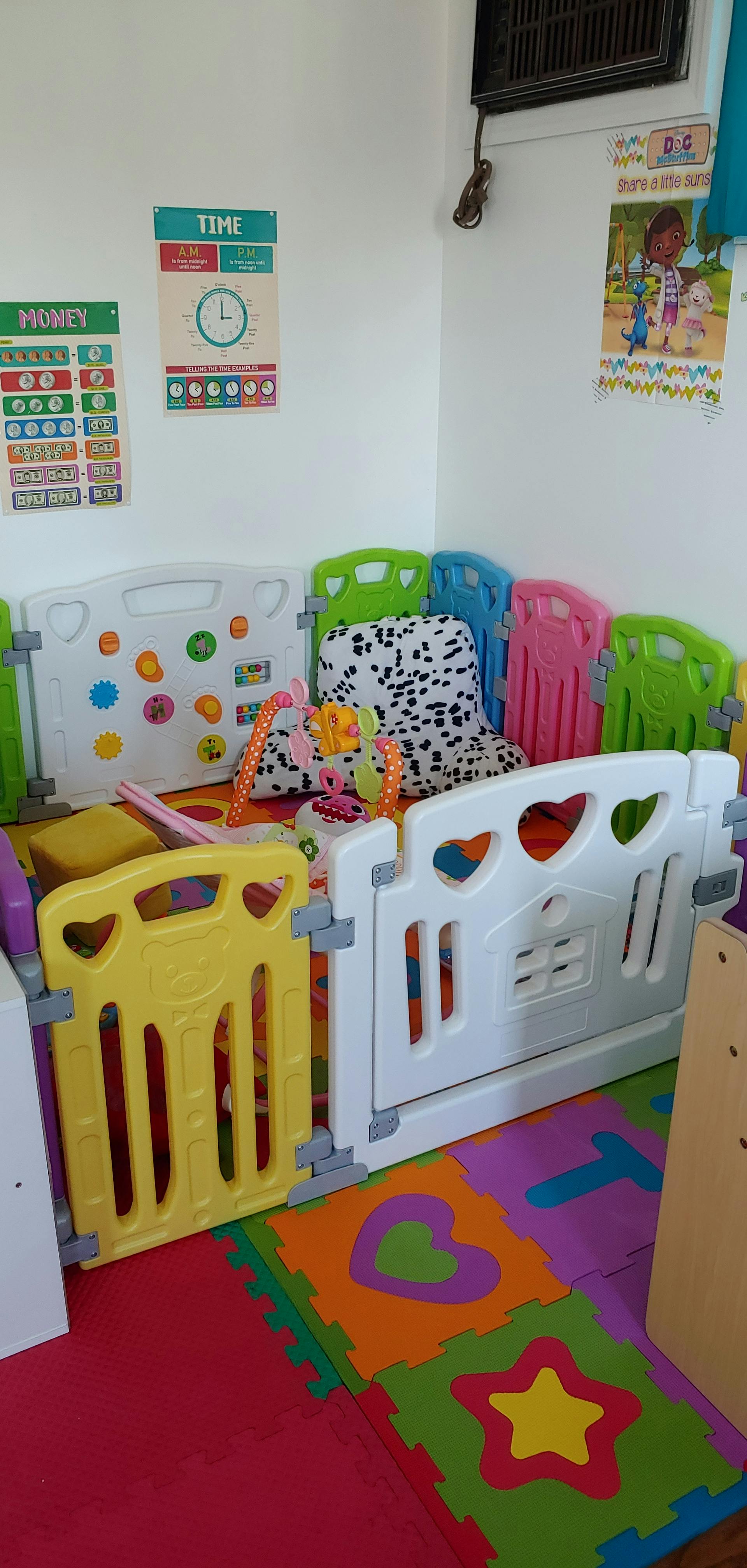 Playpen with colorful panels and foam floor mats