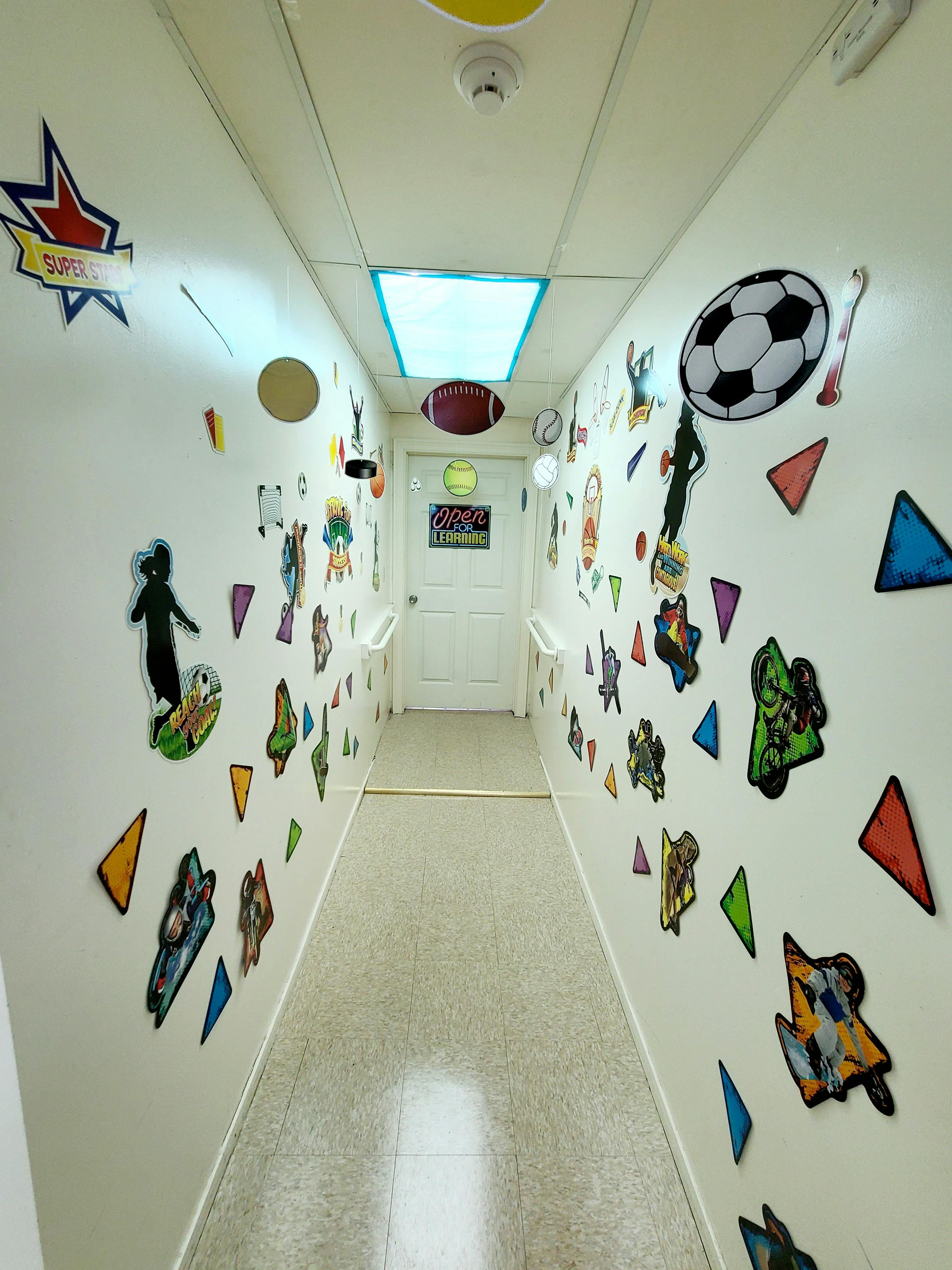 Hallway with colorful cutouts and drawings on the walls