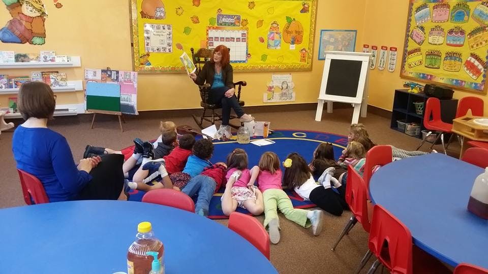 Person reading to children in a classroom