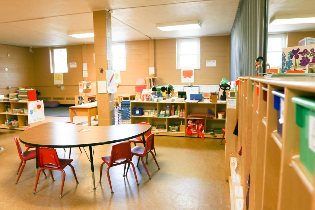 Empty classroom with small tables and chairs