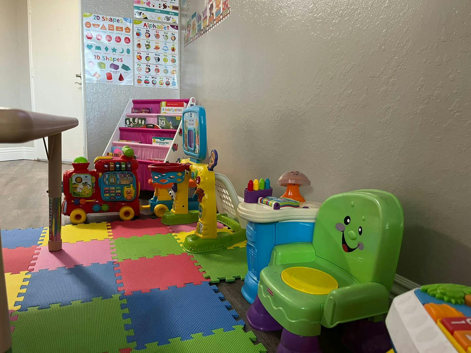 Children's play area with colorful floor mats and various toys