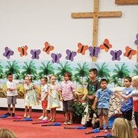 Children on a stage with butterfly decorations