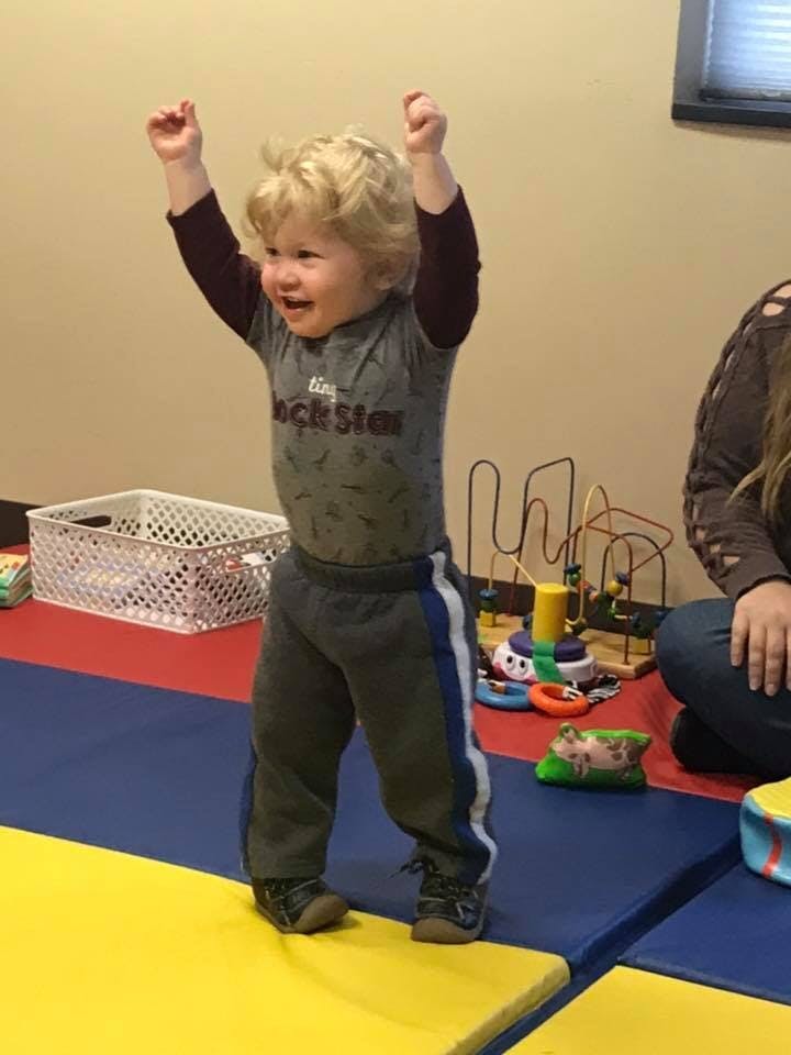 Child with arms raised in the air