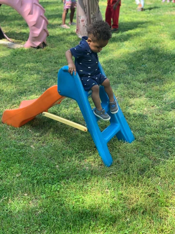 Child on a blue and orange slide