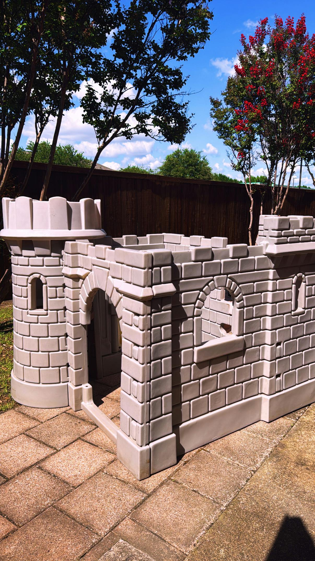 Plastic toy castle playhouse on a patio