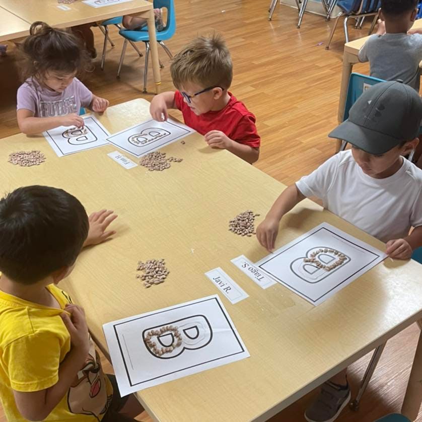 Children working on a craft project at a table