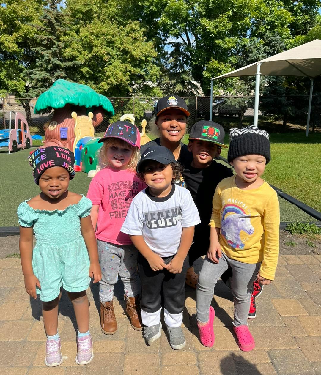 Adult and multiple children posing outdoors