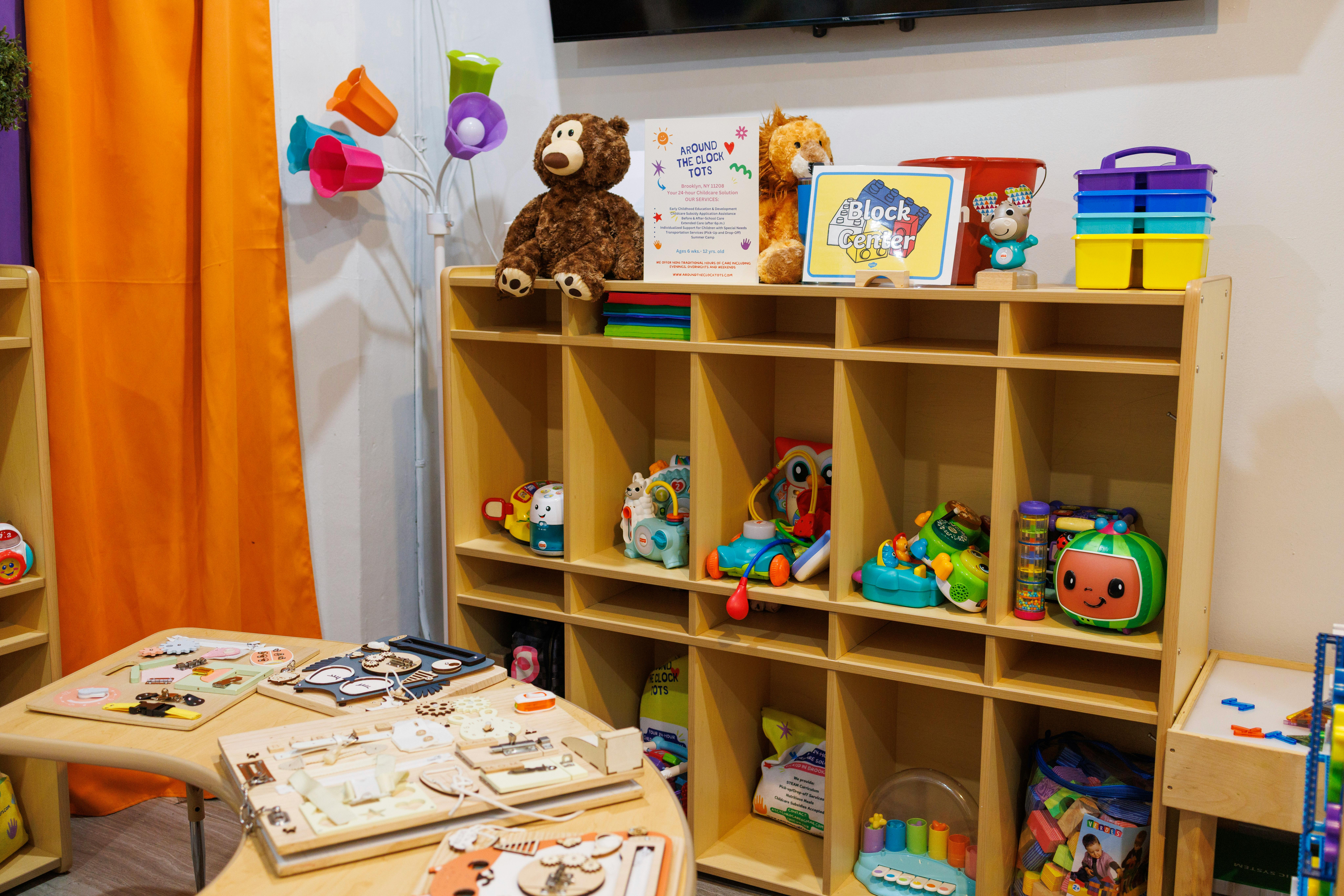 Classroom with wooden cubbies filled with toys and puzzles on a table