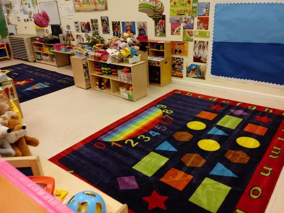 Classroom with colorful rugs and shelves