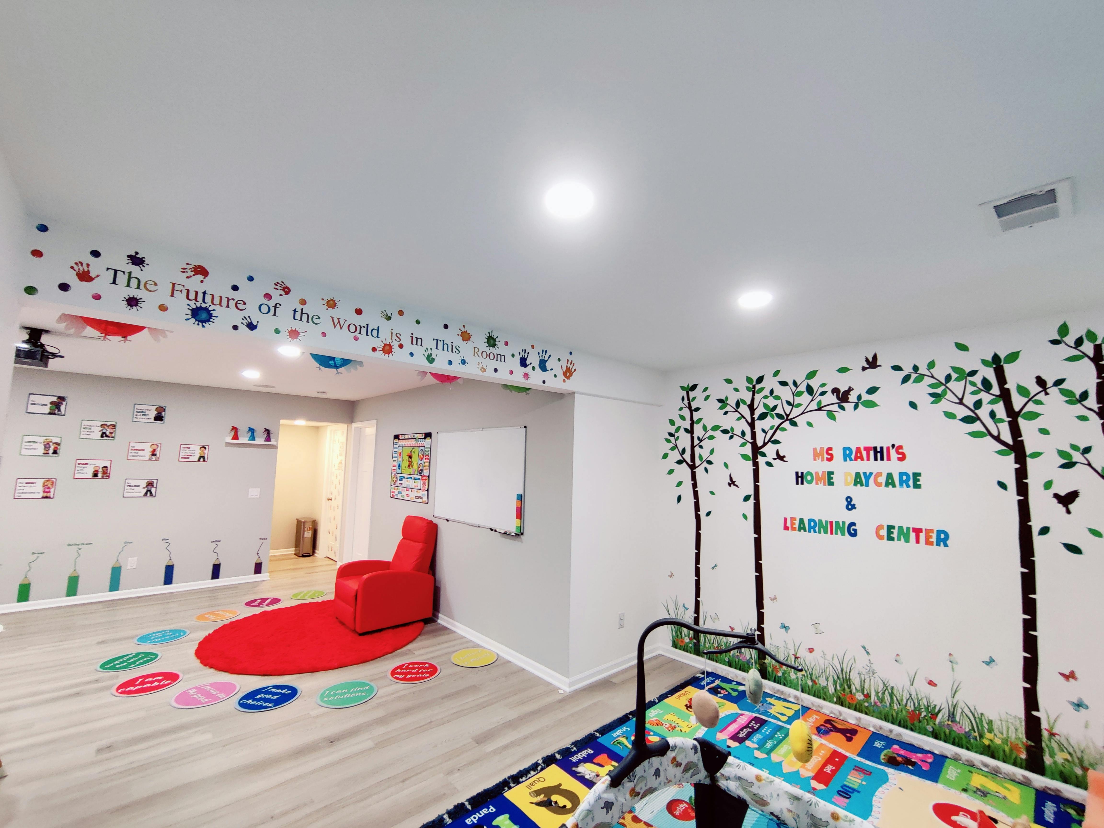 Learning center room with colorful wall decals and a red chair