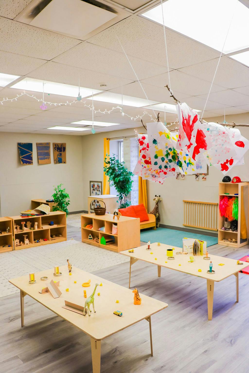 Classroom with tables, shelves, and colorful decorations