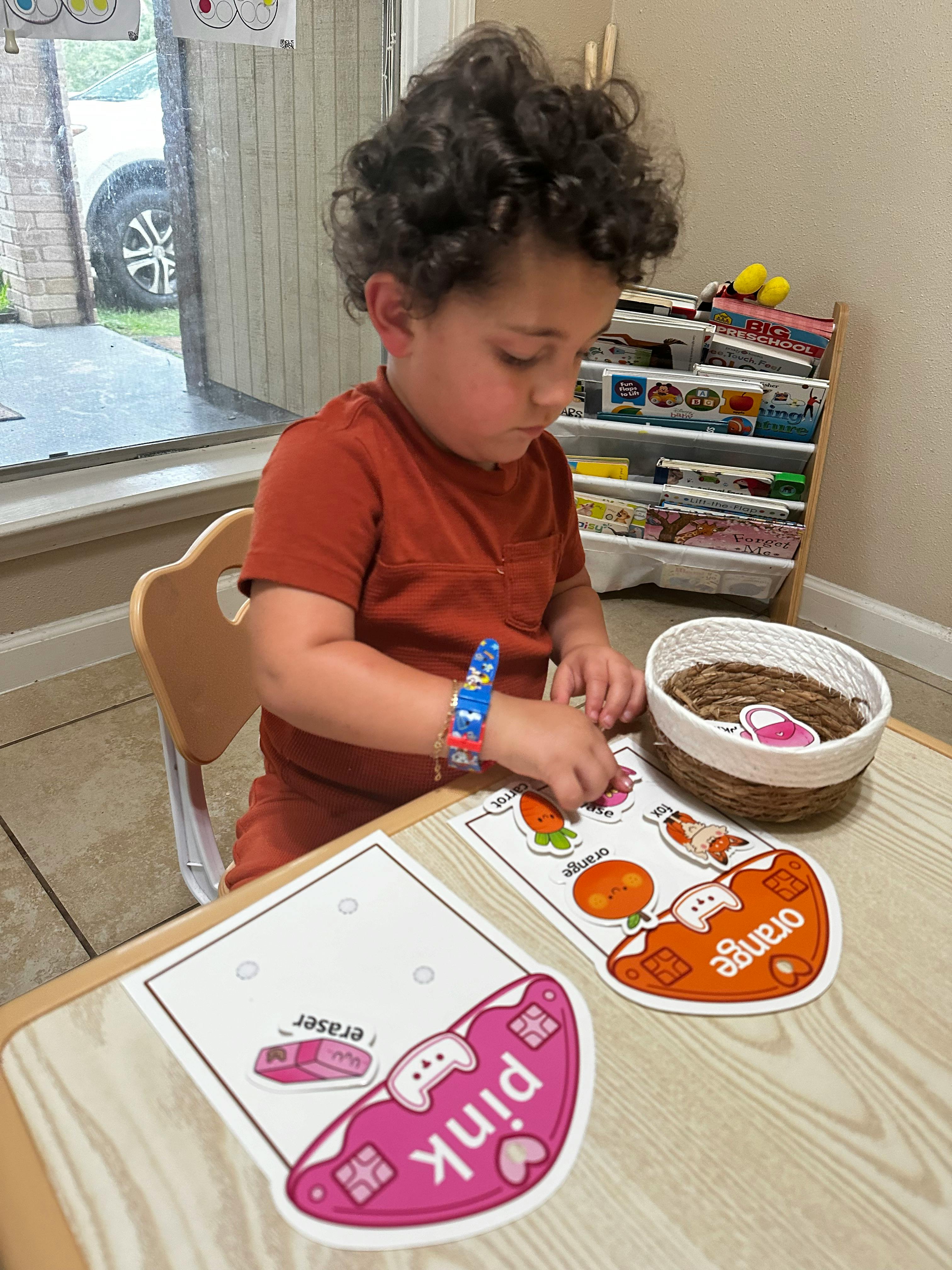 Child playing with learning cards at a table