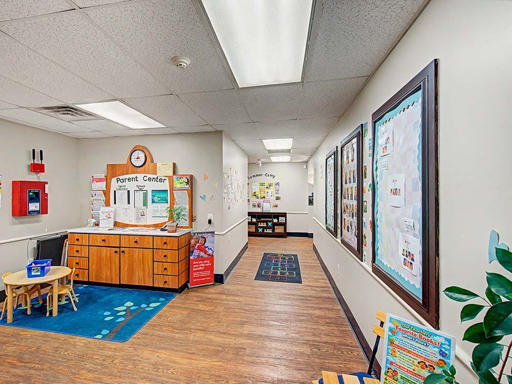 A school hallway with a "Parent Center" display, small table and chairs, and bulletin boards