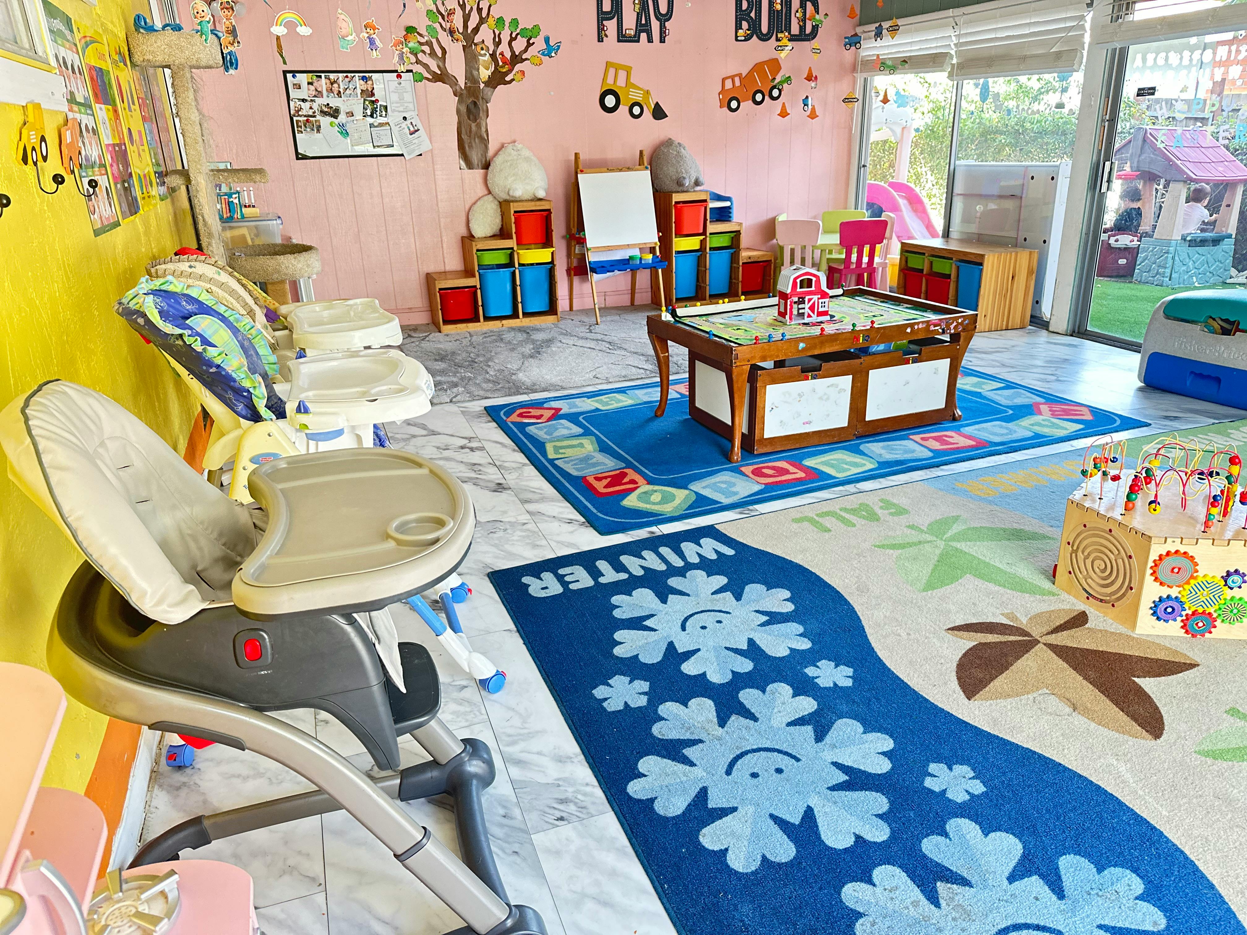 High chairs and play area with rugs and toys