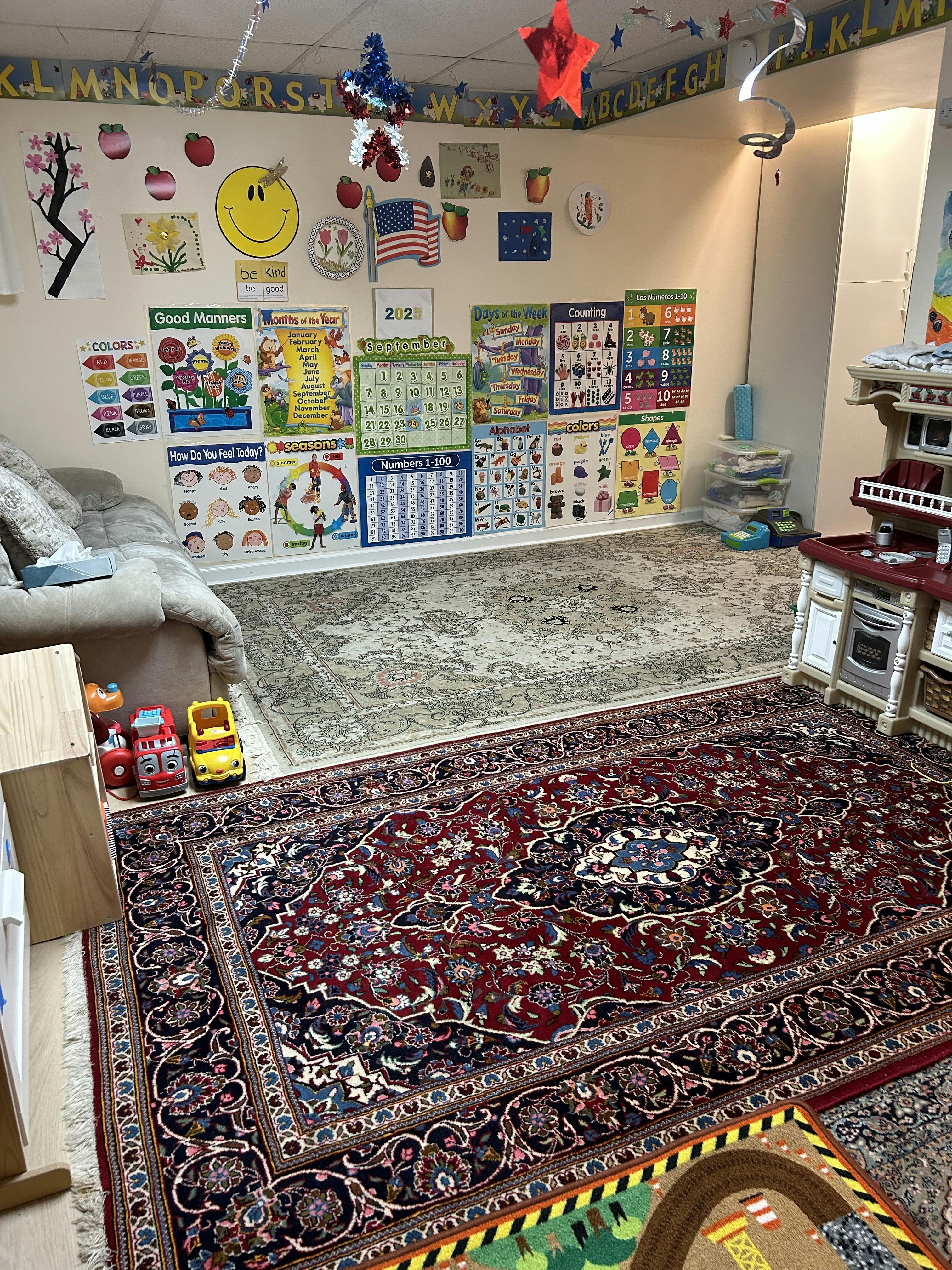 Playroom with educational posters on the wall and patterned rugs on the floor