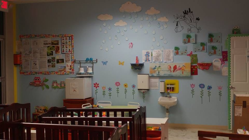 Nursery room with cribs and decorated walls