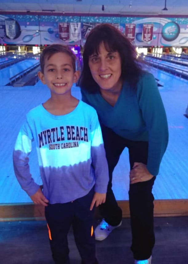 Adult and child standing in a bowling alley