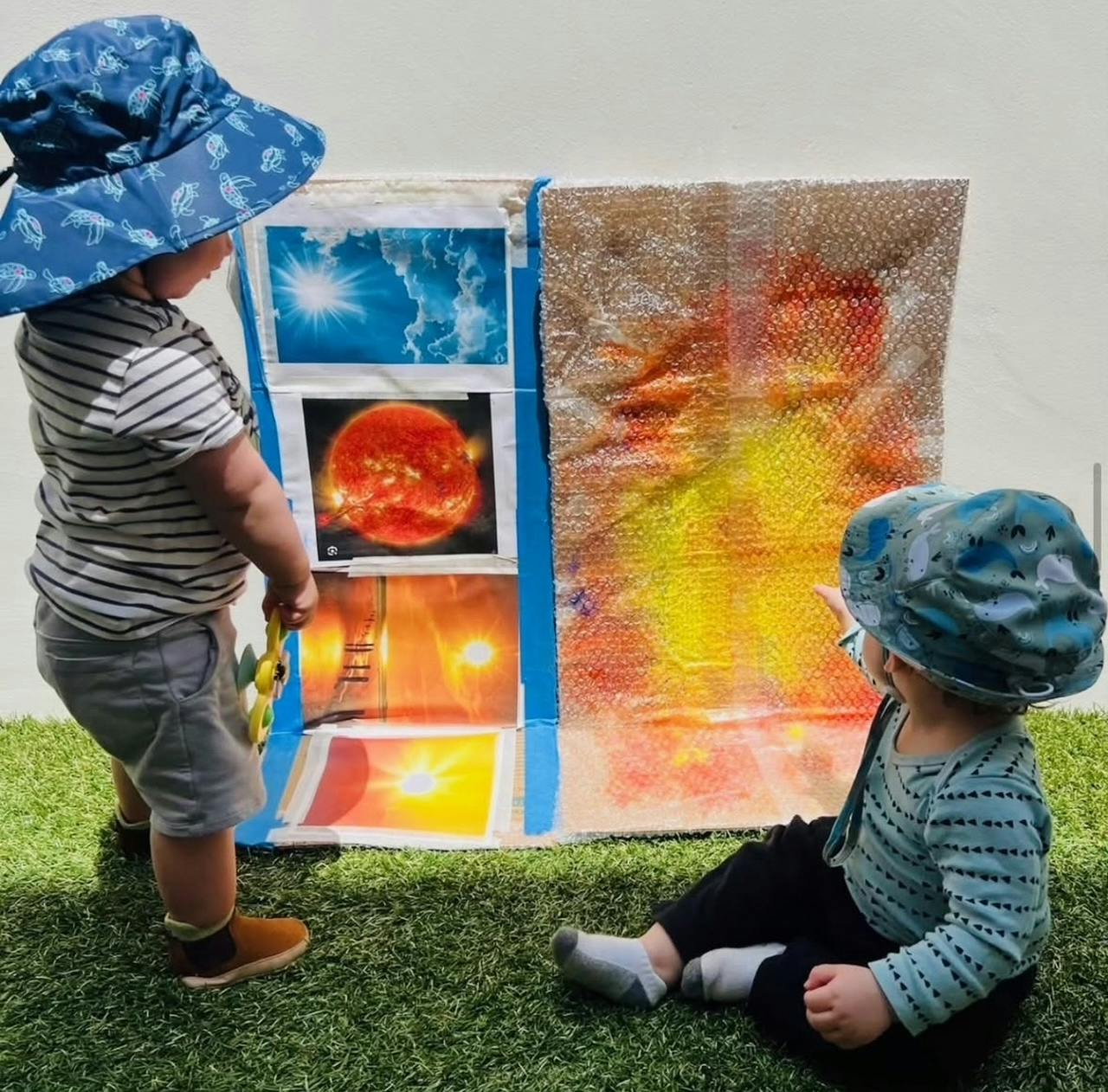 Two children looking at a display with images of the sun