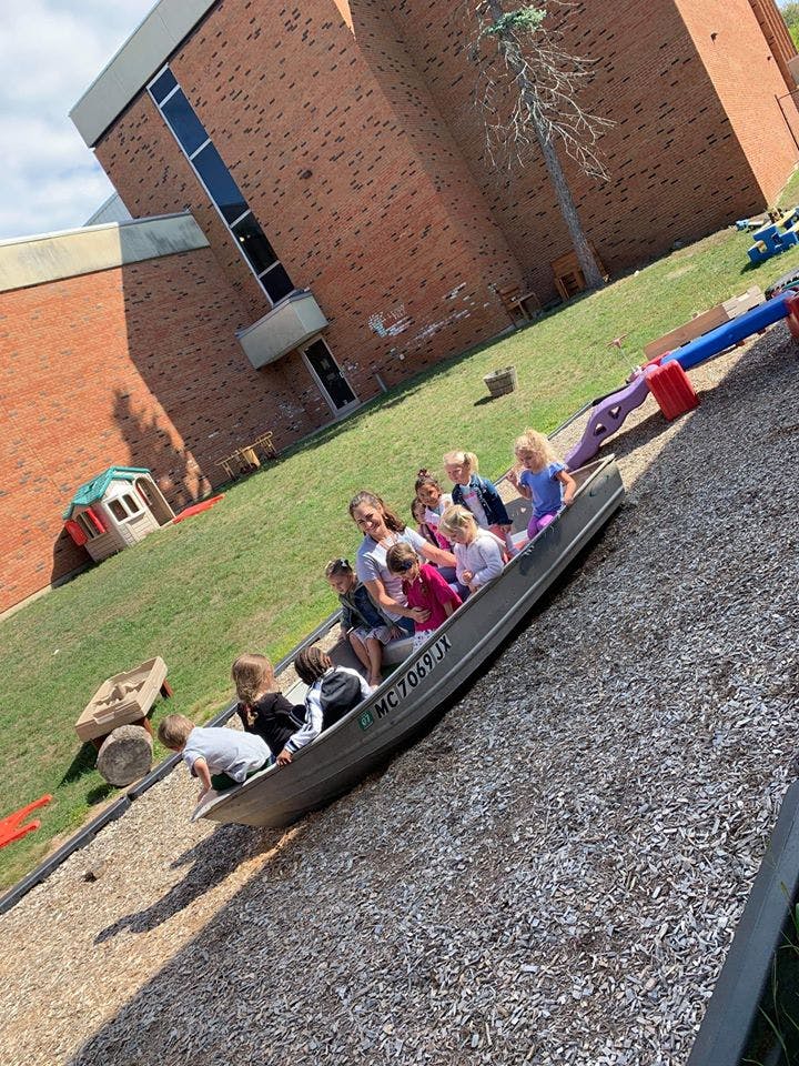 Children playing in a boat on a playground