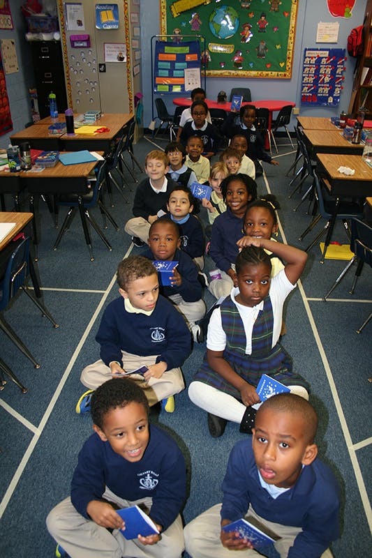 Children sitting on the floor in a classroom
