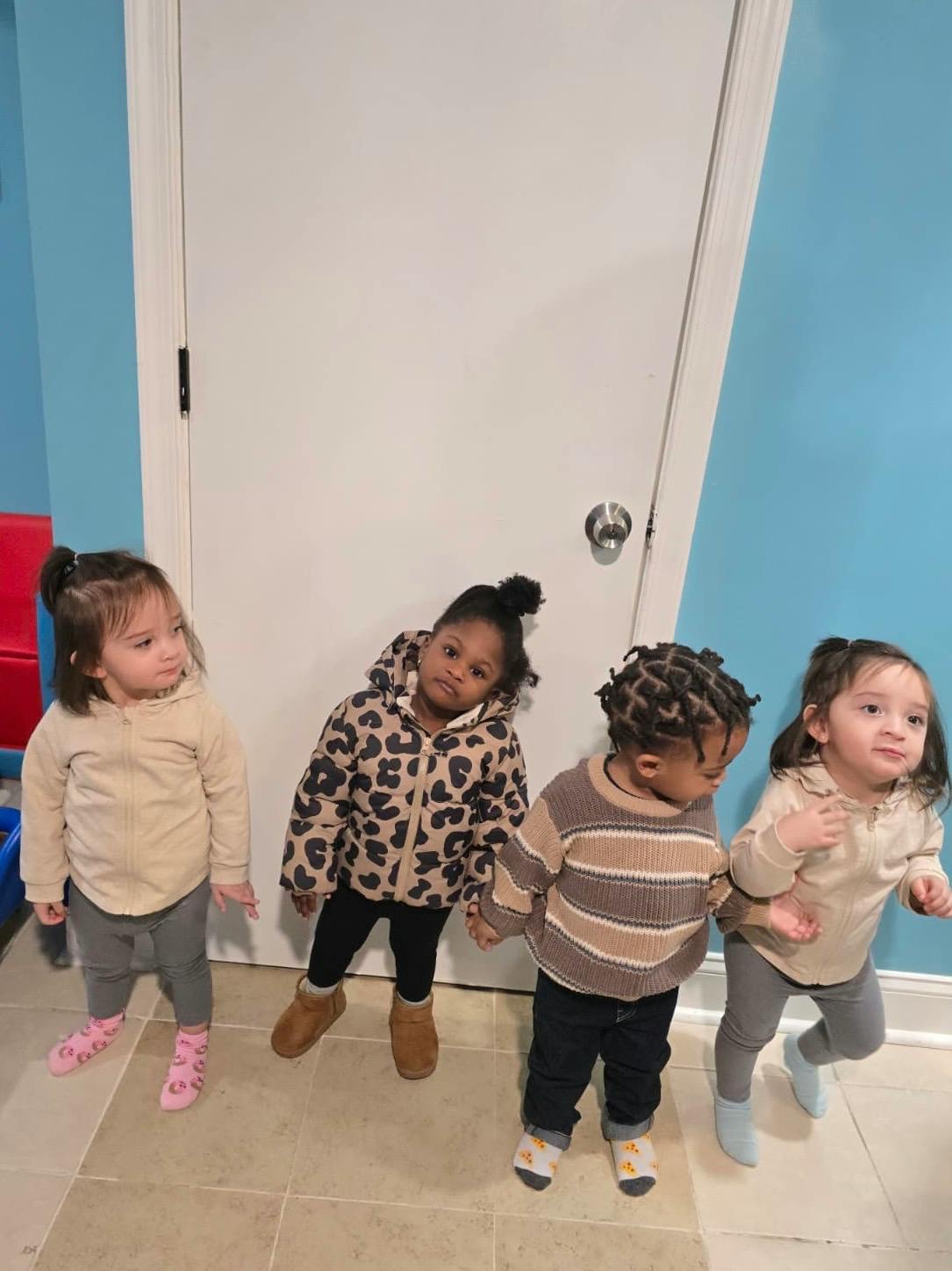 Four children standing in a row