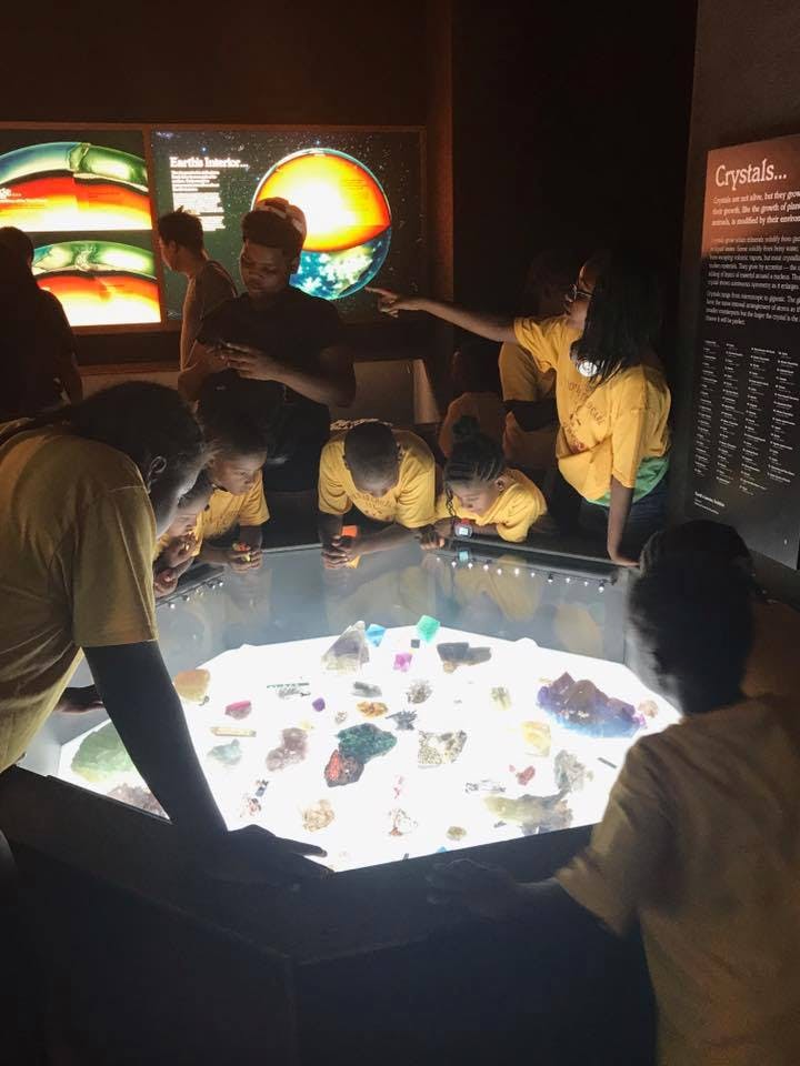 Children looking at a display of crystals in a museum
