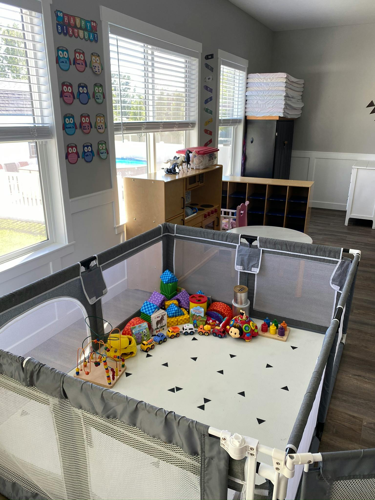 Playpen filled with various toys