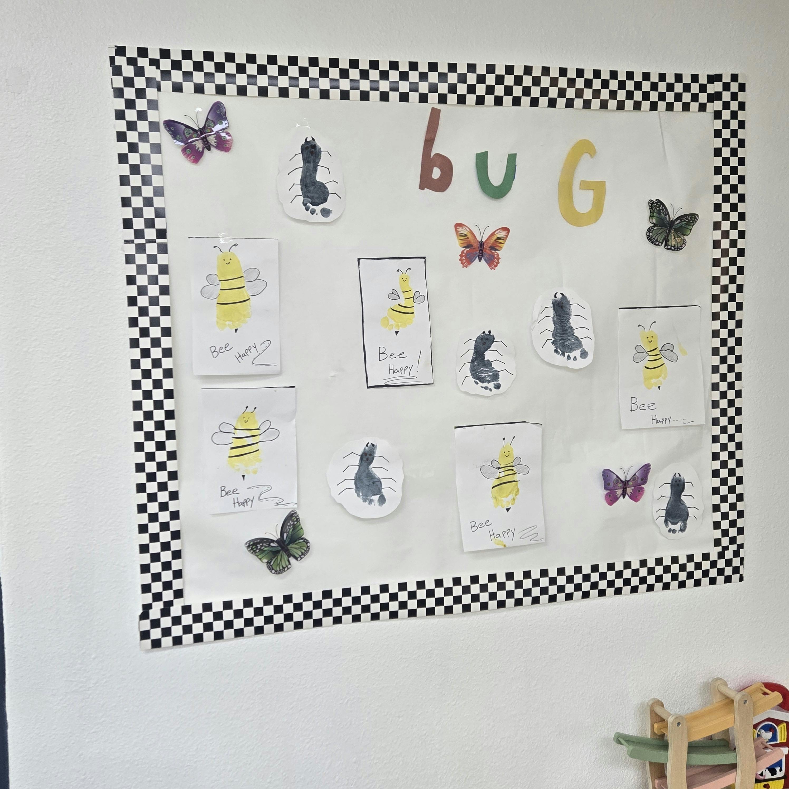 Children's artwork on a bulletin board titled "BUG"