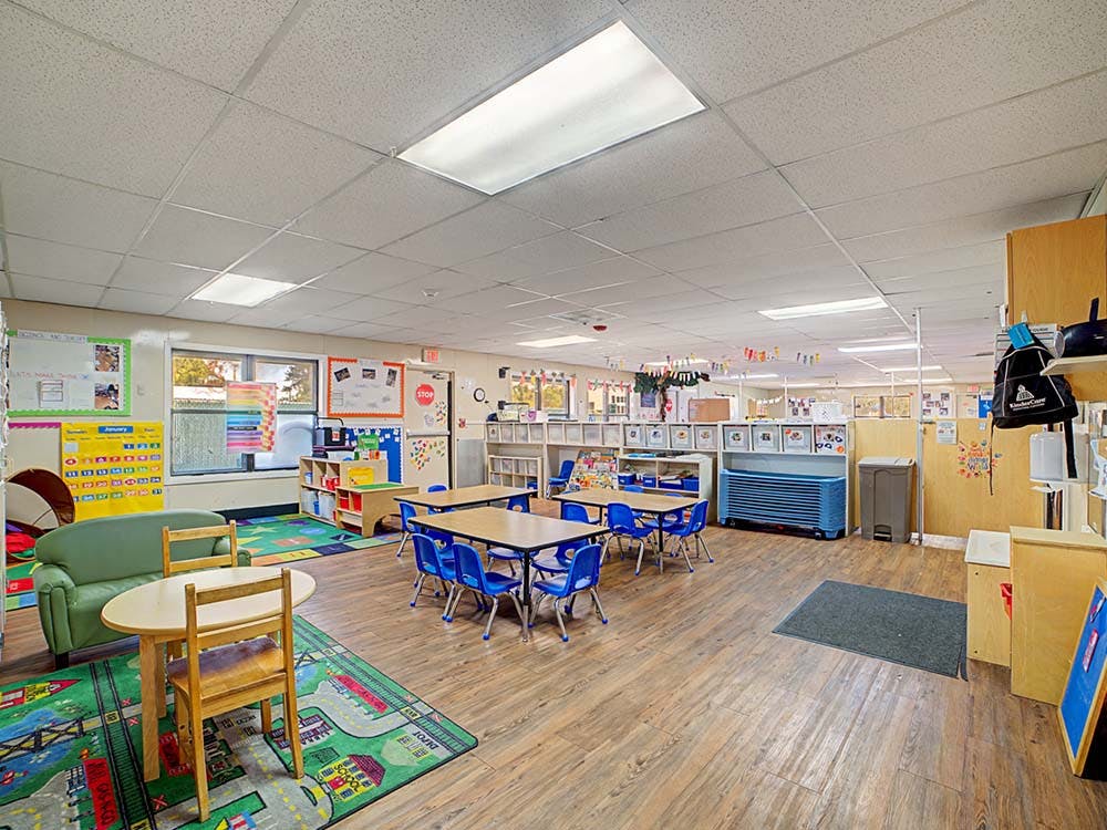 Empty colorful classroom with small tables and chairs