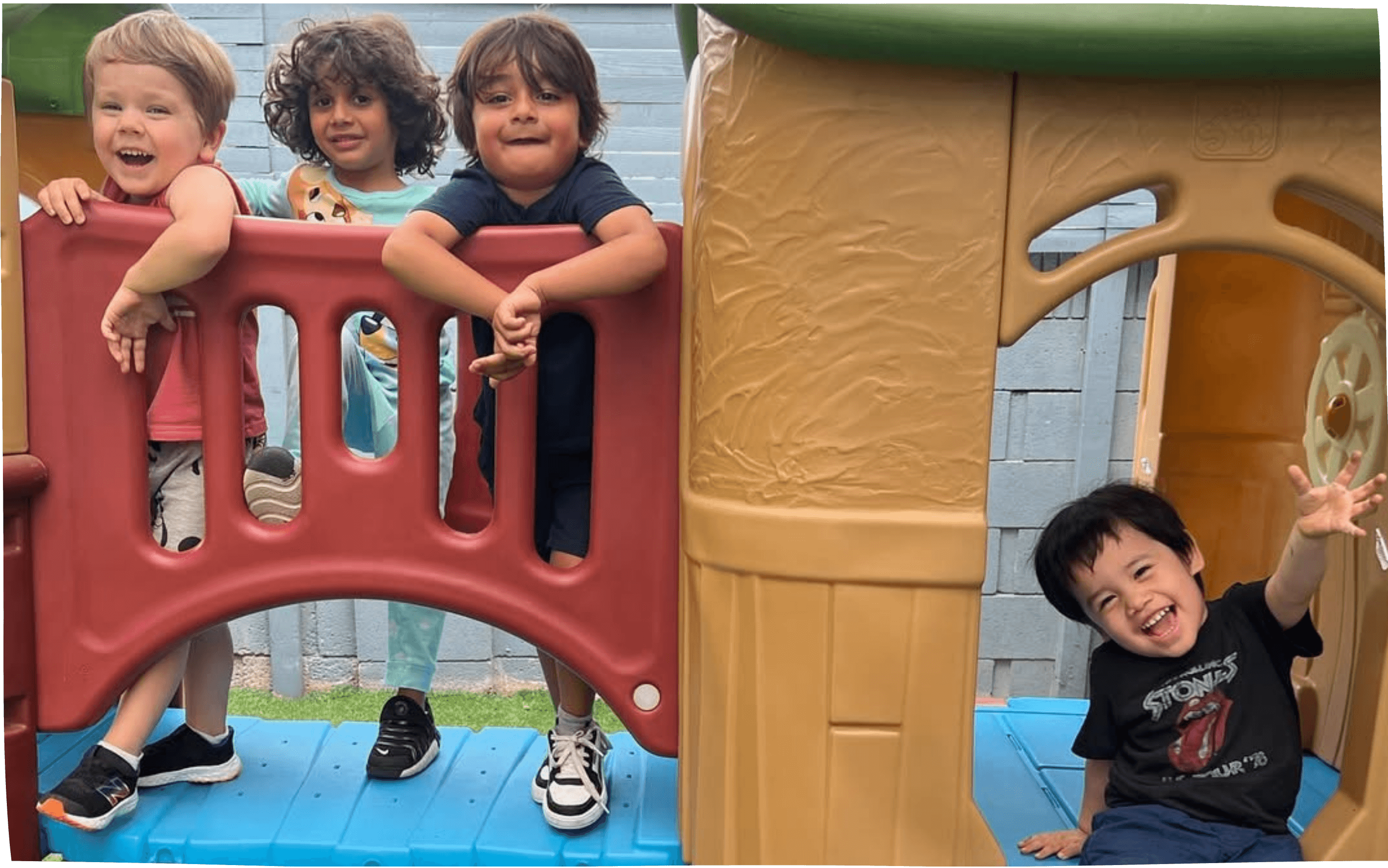Four children playing on a playground structure