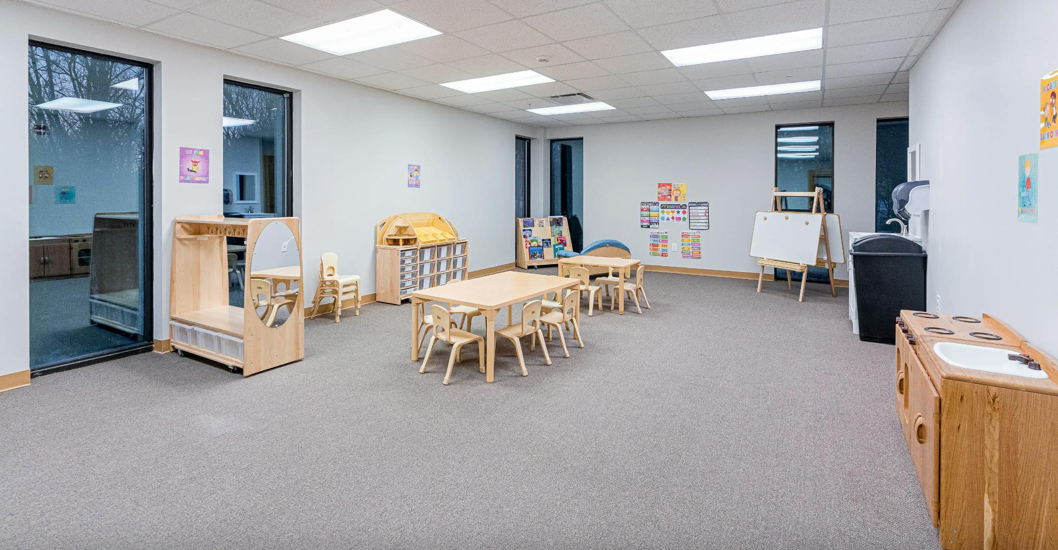 Empty classroom with small tables and chairs
