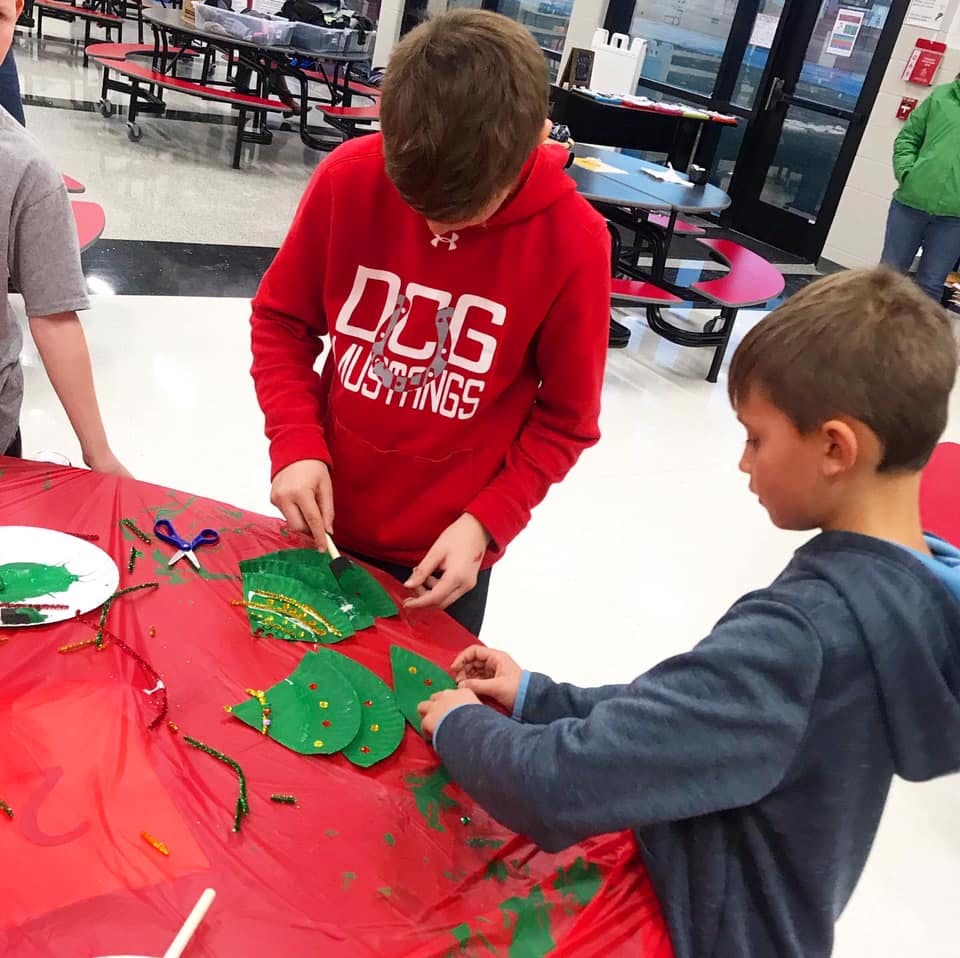 Two children doing crafts at a table