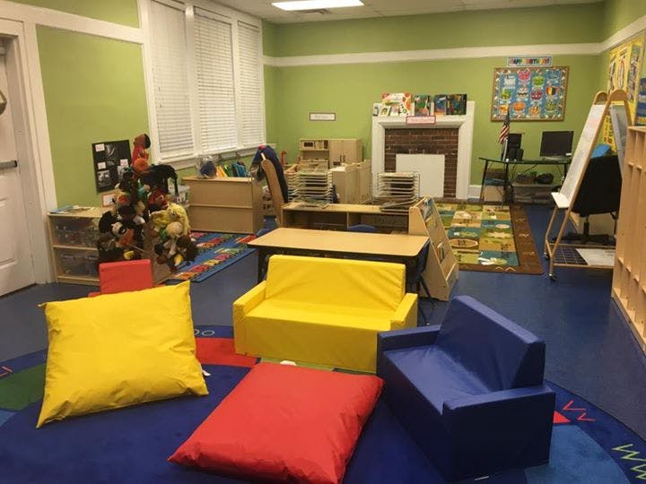 Classroom with small sofas, pillows, and learning materials